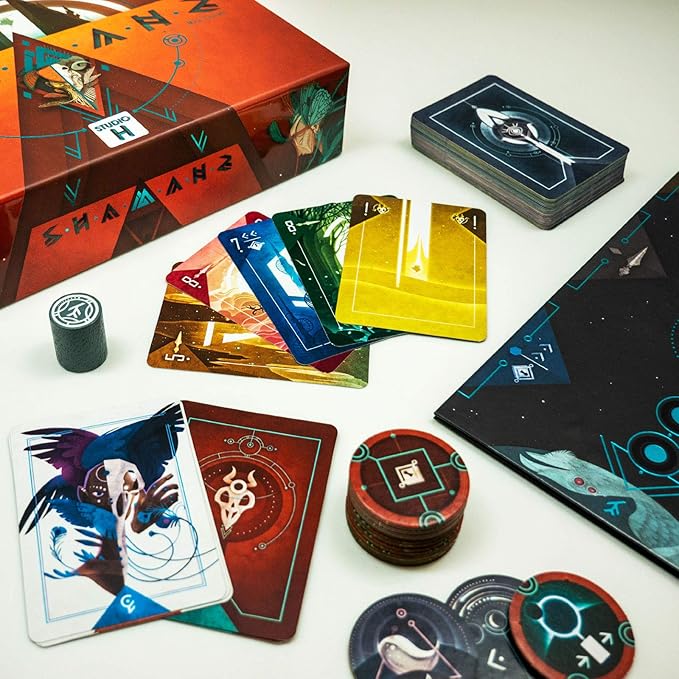 Shamans Card game with colorful cards, a box, and game pieces on a white surface